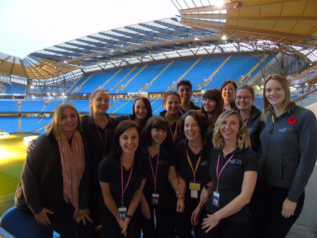 The Speech Bubble Team Members in a Stadium, Smiling